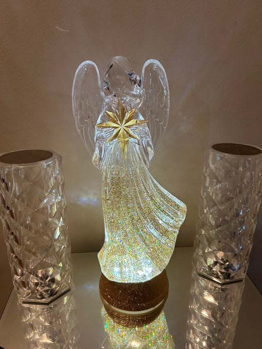 THEY’RE SELLING  FAST 🙌🏾(NOT MANY LEFT) SO GET YOU ONE! BUY MY NEW LIMITED EDITION CHRISTMAS ANGEL NOW WHILE SUPPLIES LAST! Illuminate your holiday gatherings with the enchanting charm of St. Nicholas Square. This luminous angel table decor, bathed in s